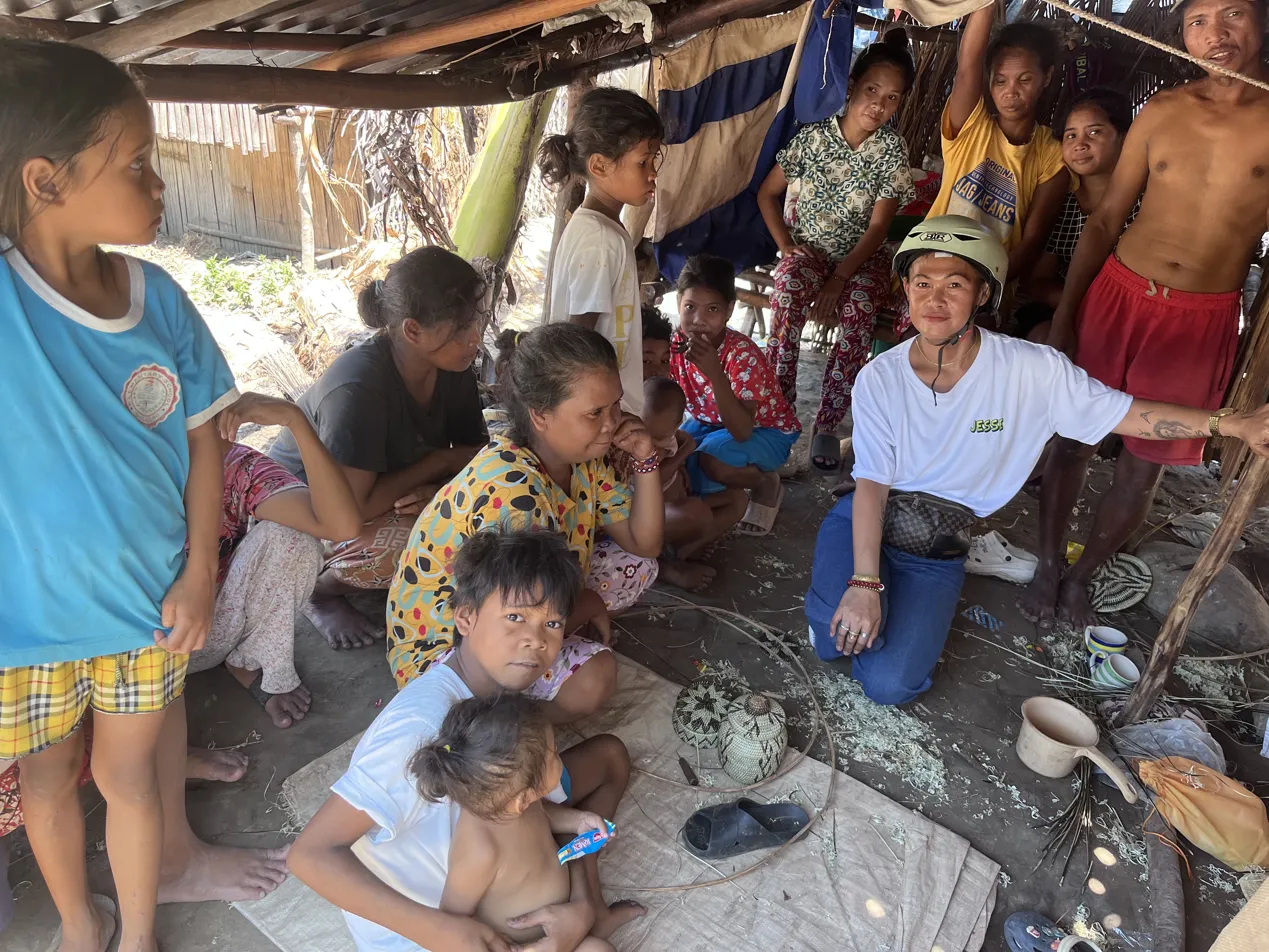 Mangyan community members weaving together