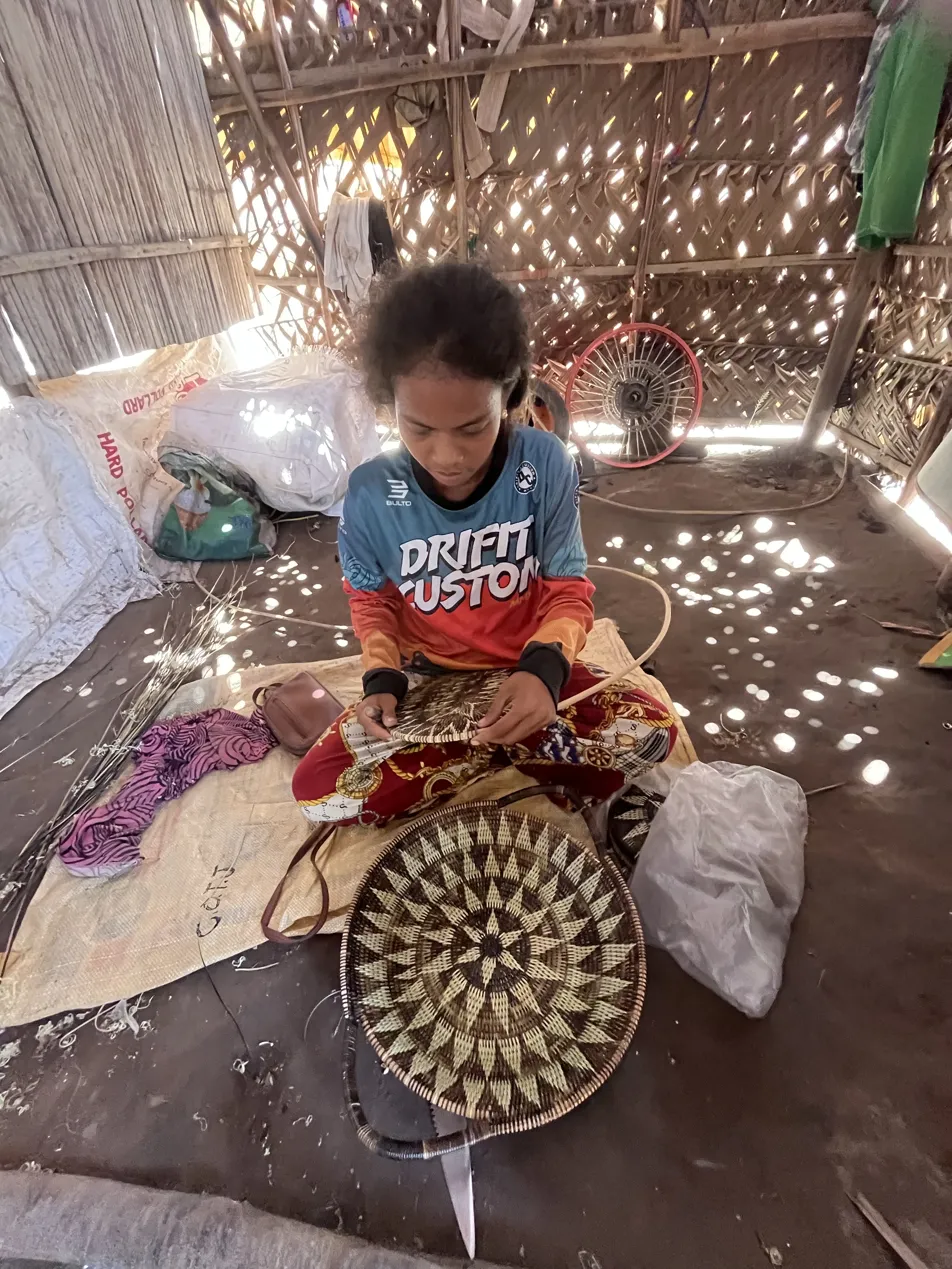 Mariel Caurang, Mangyan artisan, weaving inside her bamboo home in Mindoro, Philippines