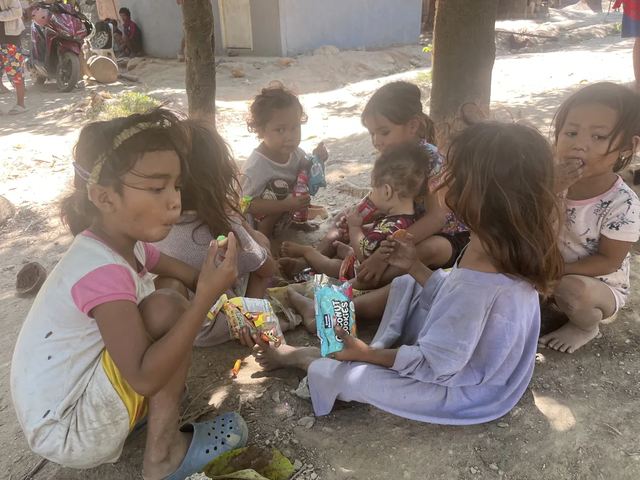 Mangyan children eating food at a community distribution in Mindoro