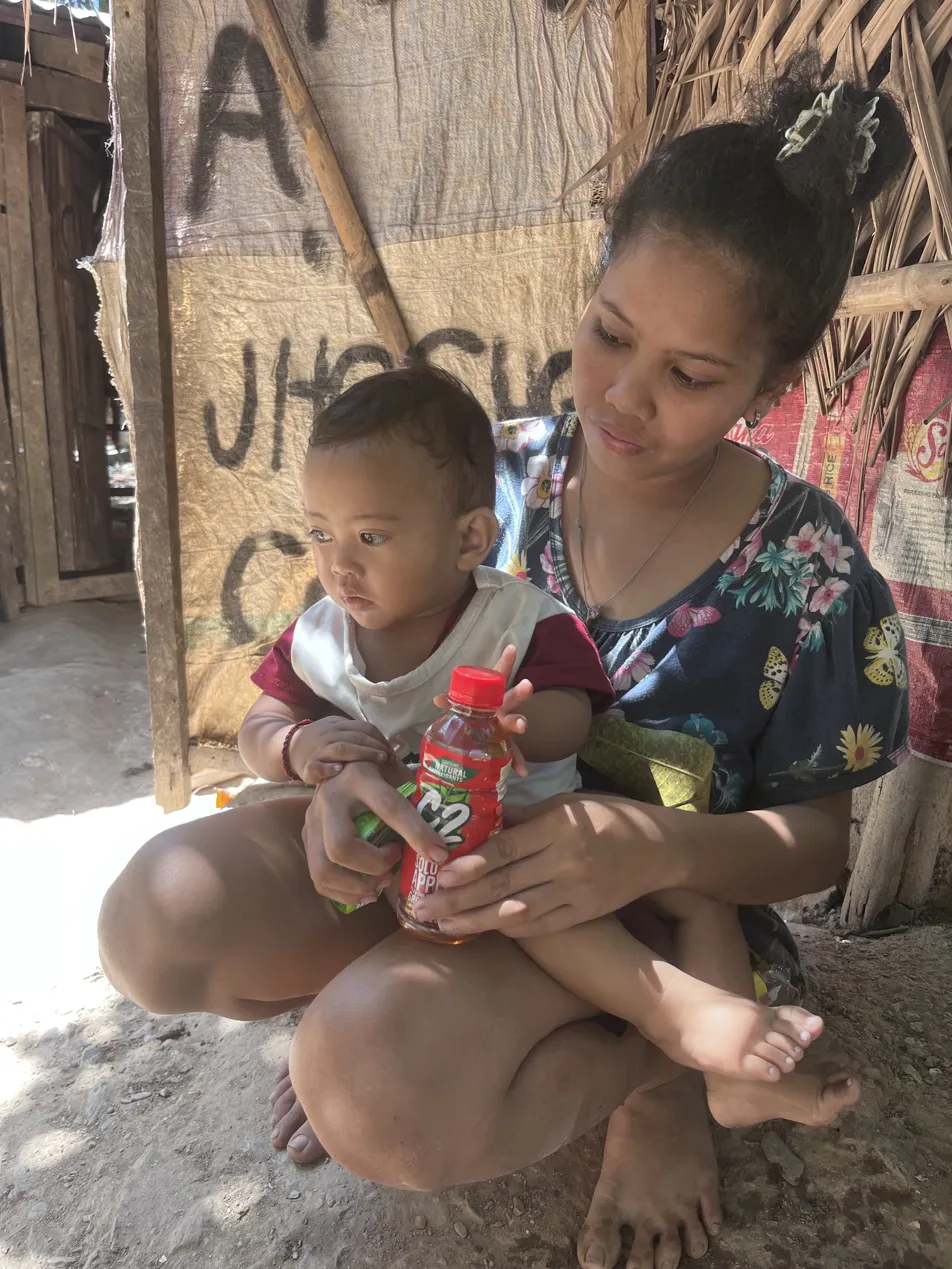 Young Mangyan mother holding her baby